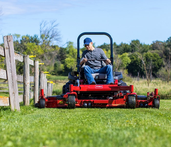 Operator cutting along the fence line 