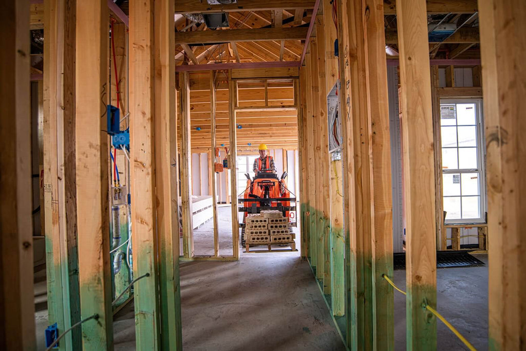 Fit in tight and narrow spaces with the Kubota SCL 1000 Stand-On Compact Loader