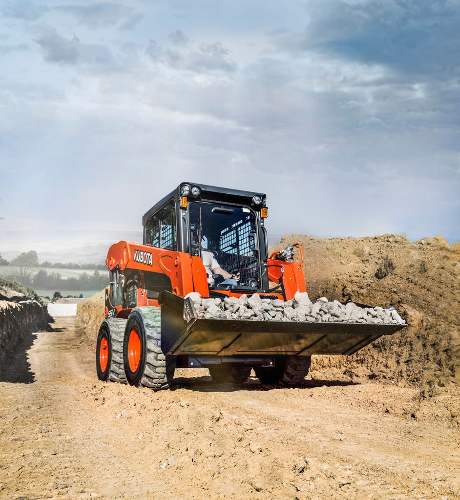 Kubota SSV65 Skid Steer carrying rock