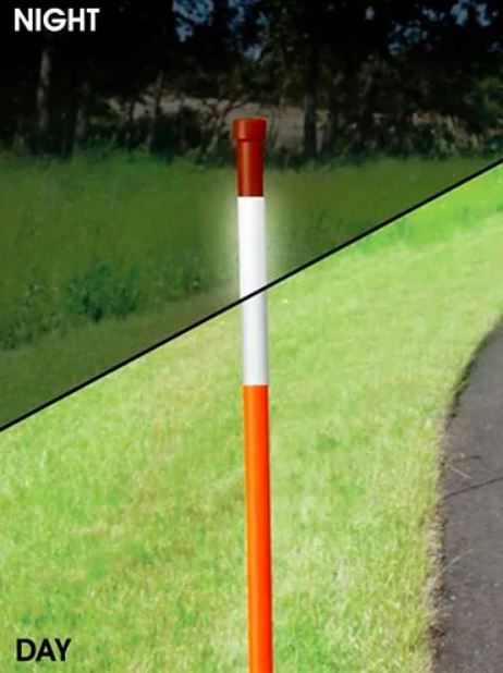Reflective orange driveway marker shown at night and during the day